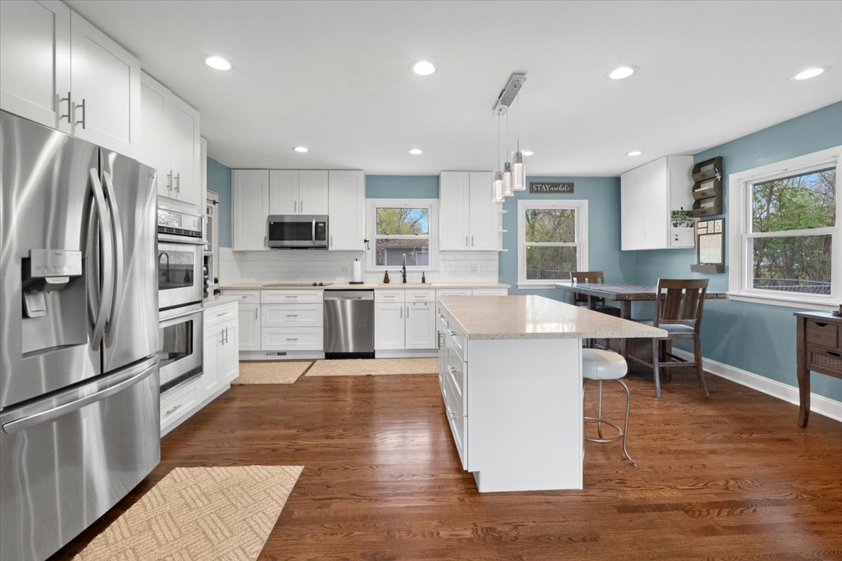 2517 Salem Boulevard Zion, IL 60099 - Photo 8 of 32 a large kitchen with kitchen island a large counter top stainless steel appliances and cabinets