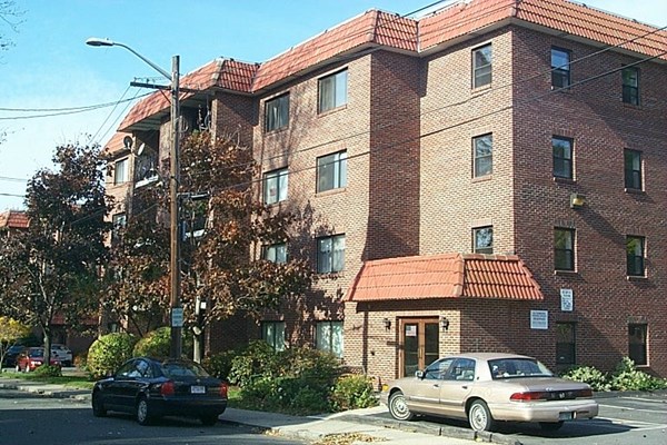 a front view of a residential apartment building with a yard