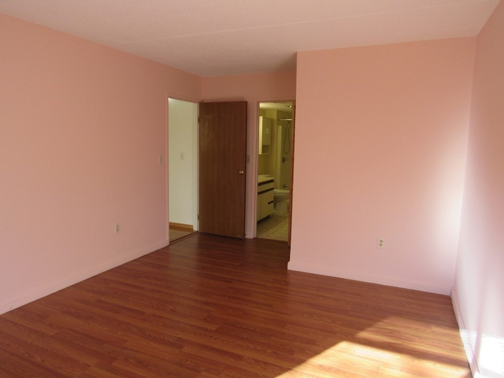8 Nahant Place, Unit 202 Lynn, MA 01902 - Photo 14 of 24 a view of an empty room with wooden floor and closet