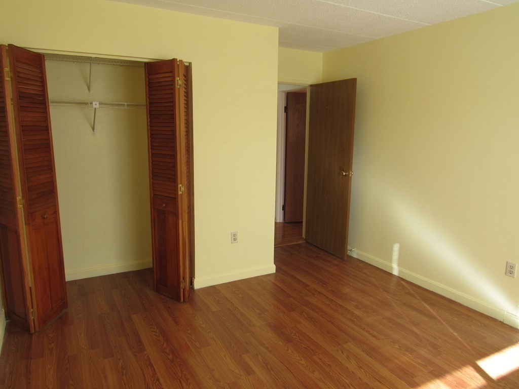 8 Nahant Place, Unit 202 Lynn, MA 01902 - Photo 18 of 24 an empty room with wooden floor and closet