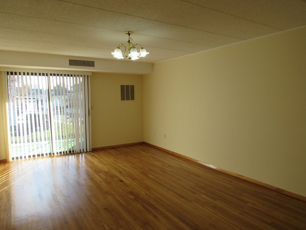 8 Nahant Place, Unit 202 Lynn, MA 01902 - Photo 5 of 24 a view of a livingroom with wooden floor and a large window