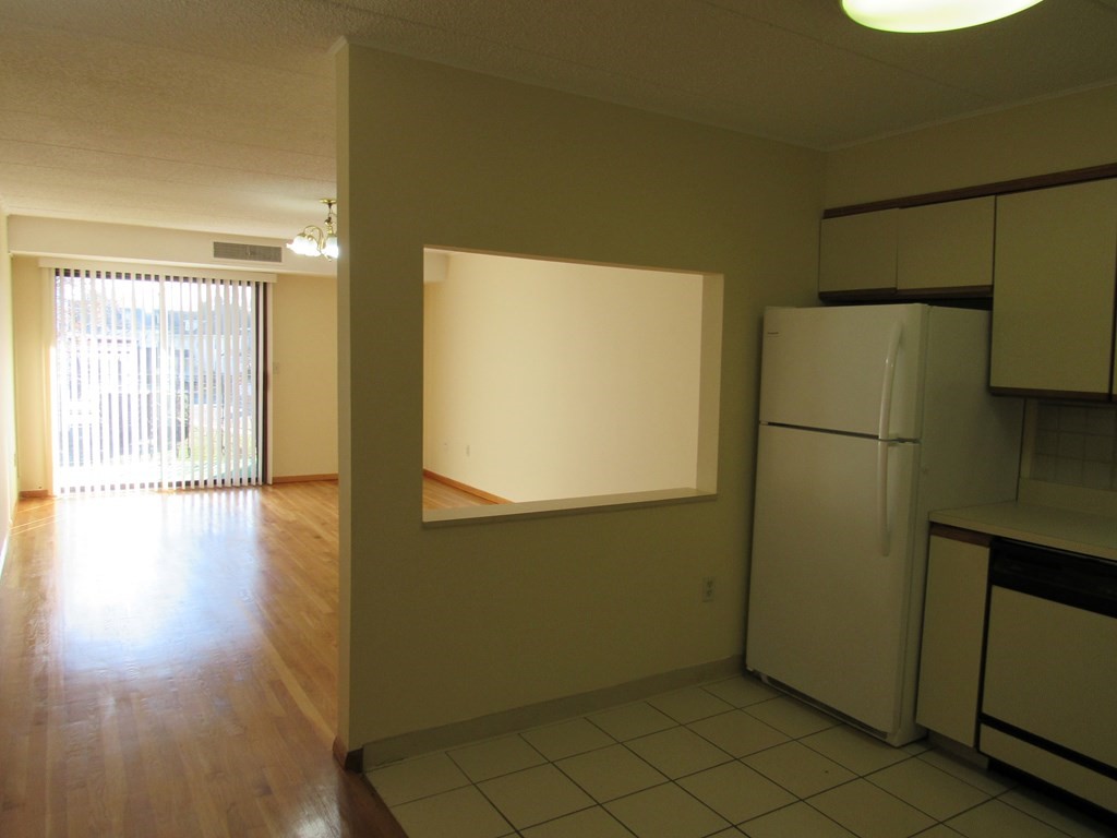 8 Nahant Place, Unit 202 Lynn, MA 01902 - Photo 6 of 24 a view of an empty room with wooden floor and a window