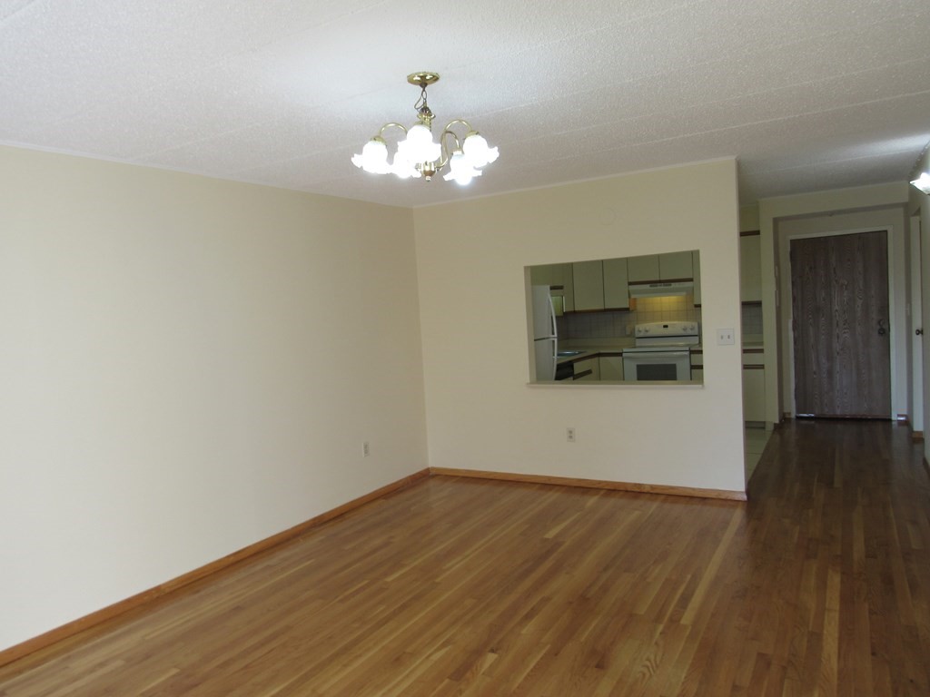 8 Nahant Place, Unit 202 Lynn, MA 01902 - Photo 7 of 24 a view of a room with wooden floor and ceiling fan