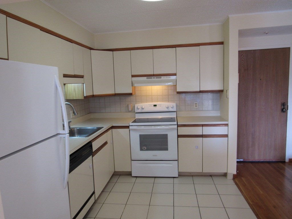 8 Nahant Place, Unit 202 Lynn, MA 01902 - Photo 10 of 24 a kitchen with a stove top oven and cabinets