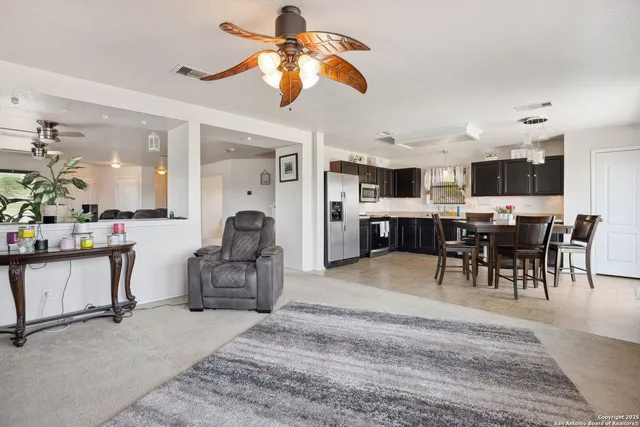 a living room with lots of furniture and a chandelier
