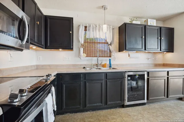 a kitchen with stainless steel appliances a stove sink and cabinets
