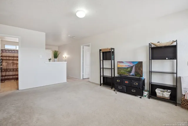 a view of a livingroom with furniture and a flat screen tv
