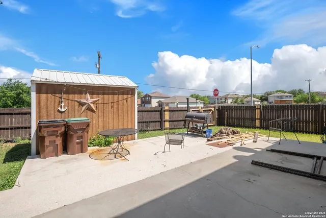 a view of a house with backyard and sitting area