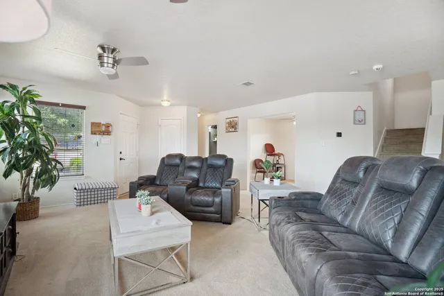 a living room with furniture and a chandelier