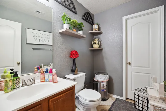 a bathroom with a toilet sink and mirror