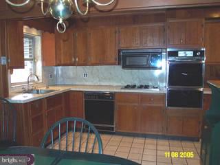 737 Grant Road Folcroft, PA 19032 - Photo 3 of 6 a kitchen with kitchen island granite countertop a sink cabinets and stainless steel appliances