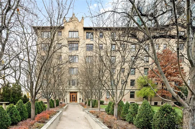 a large building with a trees in front of it