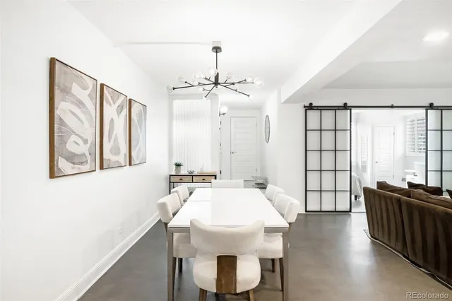 a view of a a dining room with furniture window and wooden floor
