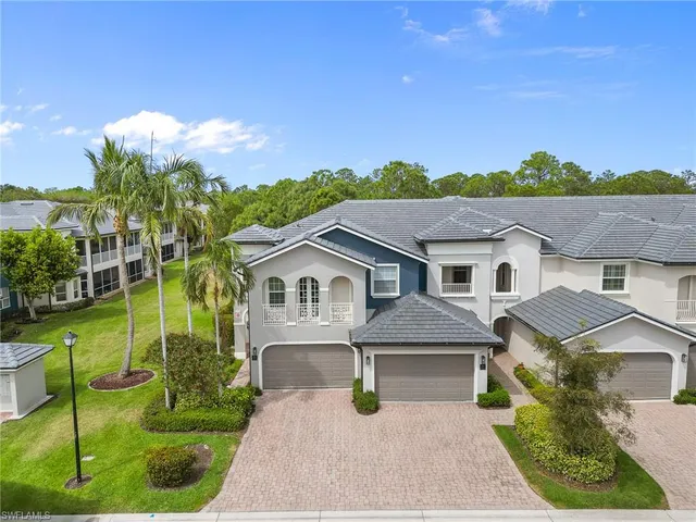 a view of a house with a big yard plants and large trees