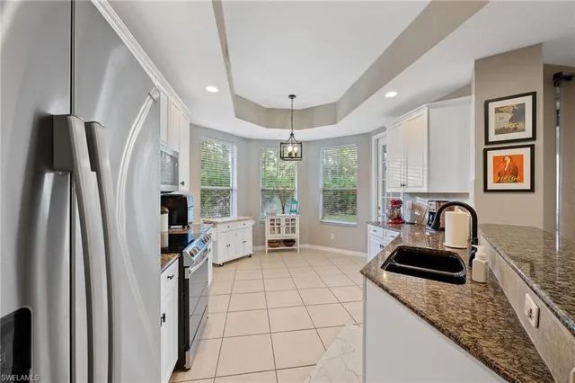 a kitchen with sink refrigerator and window