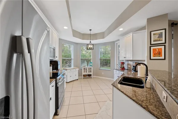 a kitchen with sink refrigerator and window