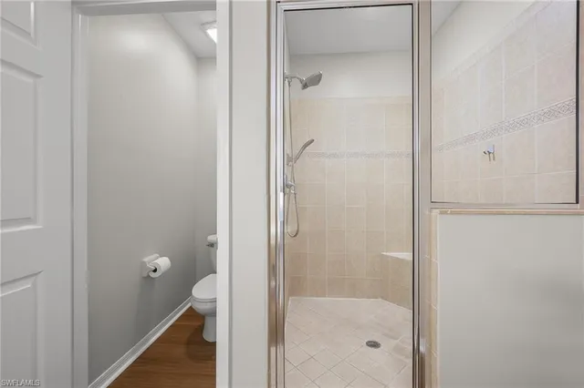 a bathroom with a glass shower door