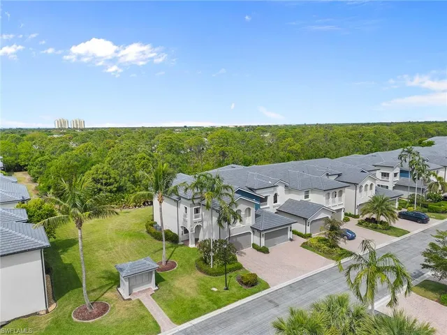 an aerial view of a house with a garden and swimming pool