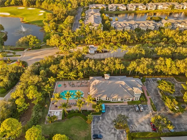 an aerial view of a residential houses with yard