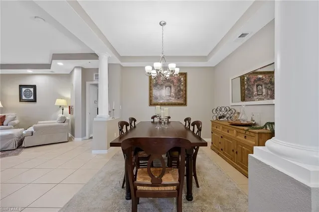 a view of a dining room with furniture and chandelier
