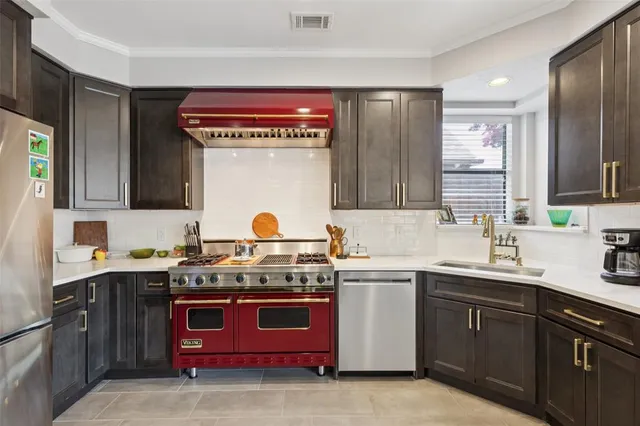 a kitchen with a sink stove and cabinets