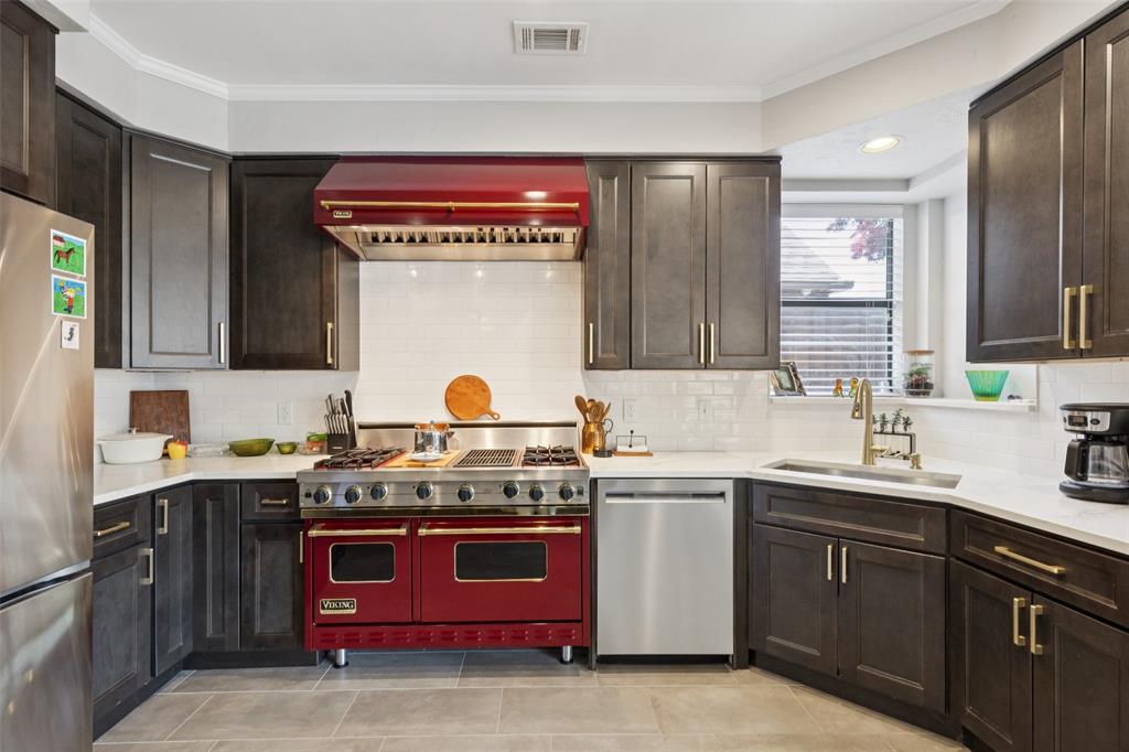 a kitchen with a sink stove and cabinets