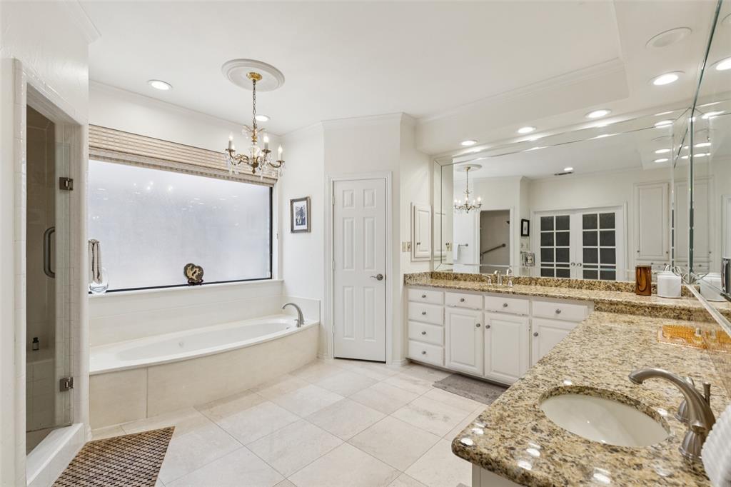 4136 Rainsong Drive Dallas, TX 75287 - Photo 15 of 30 a bathroom with a granite countertop sink a toilet a mirror and shower