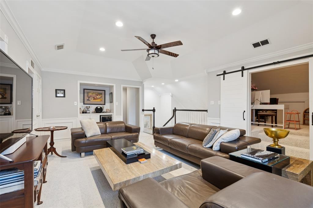 4136 Rainsong Drive Dallas, TX 75287 - Photo 20 of 30 a living room with furniture ceiling fan and a rug