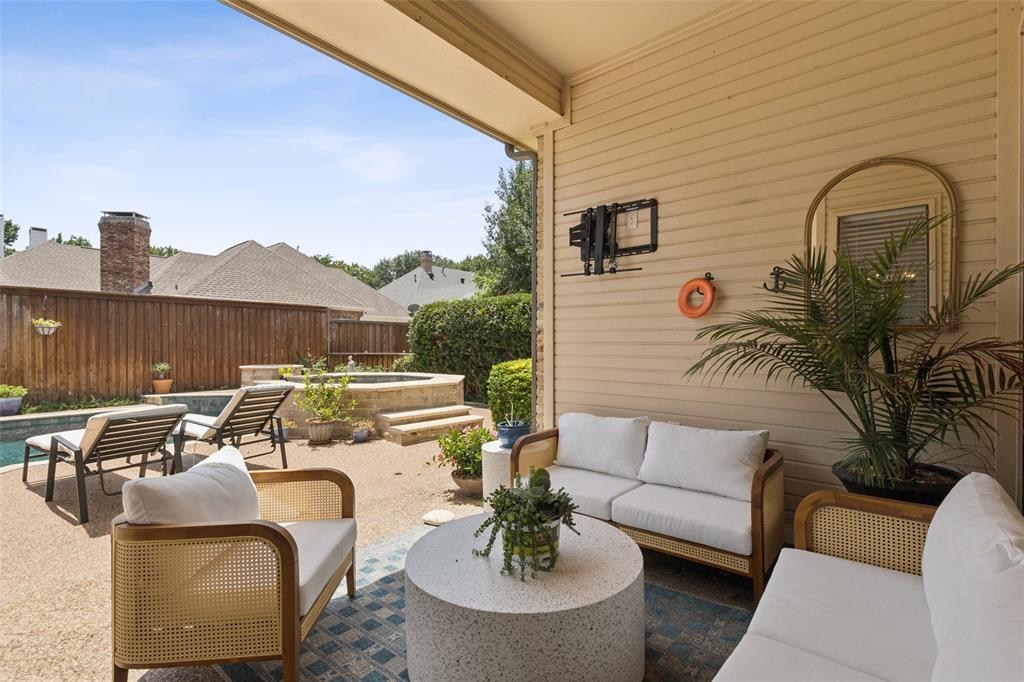 4136 Rainsong Drive Dallas, TX 75287 - Photo 27 of 30 a view of a patio with couches table and chairs with potted plants