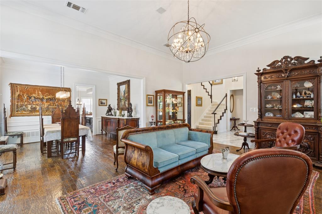4136 Rainsong Drive Dallas, TX 75287 - Photo 29 of 30 a living room with dining table and a chandelier