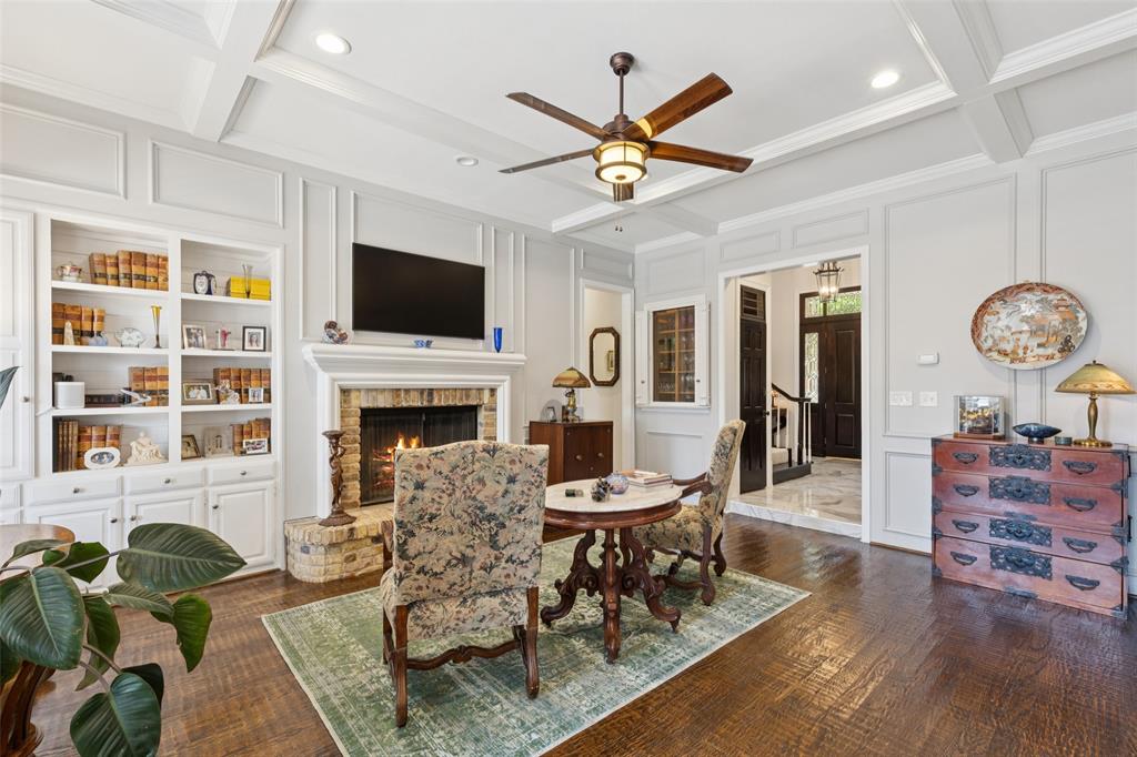 4136 Rainsong Drive Dallas, TX 75287 - Photo 7 of 30 a living room with furniture a flat screen tv and a fireplace