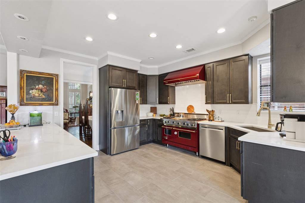 4136 Rainsong Drive Dallas, TX 75287 - Photo 9 of 30 a kitchen with refrigerator and cabinets