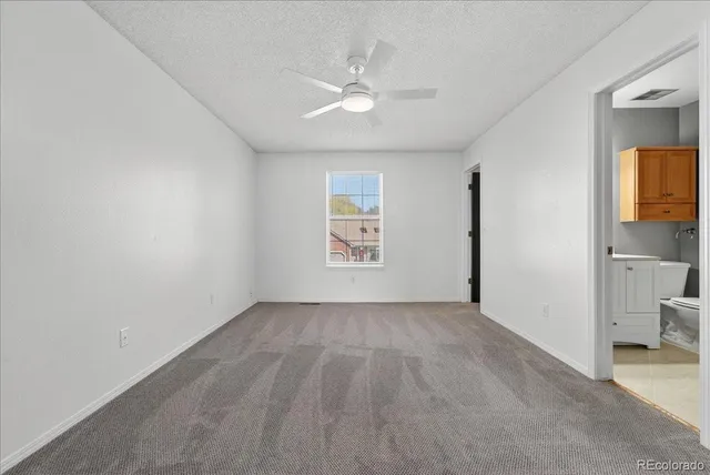 an empty room with a bathroom and a sink