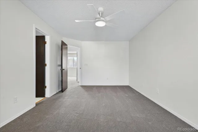 an empty room with a ceiling fan and a ceiling fan