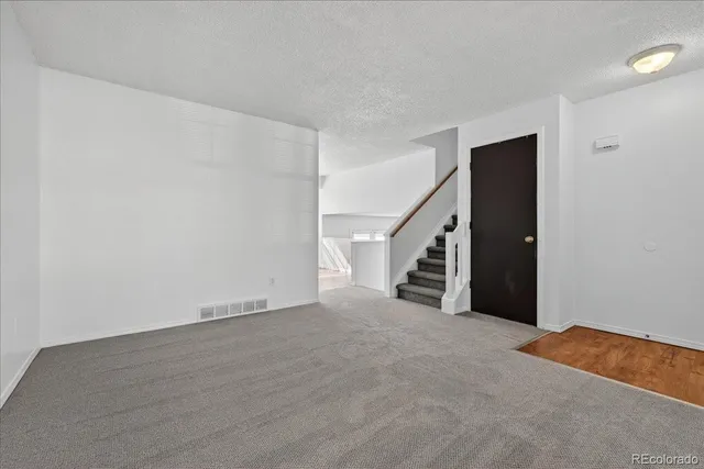 a view of an empty room with stairs
