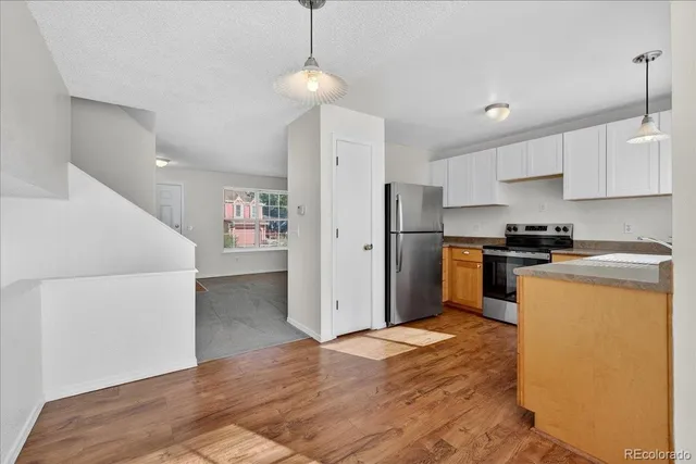 a kitchen with stainless steel appliances a refrigerator and a stove top oven