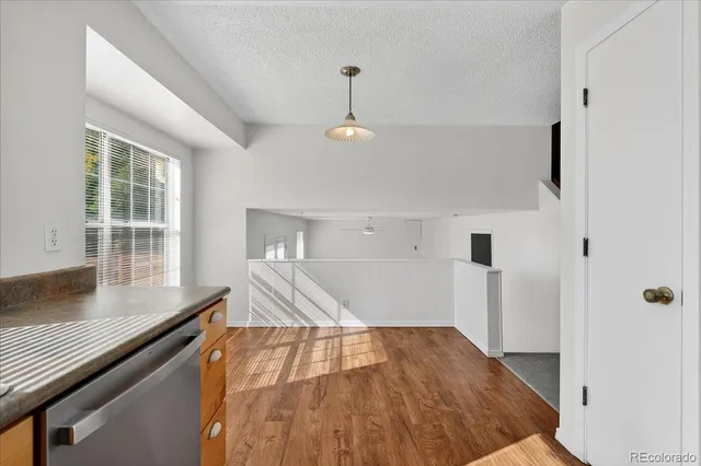 a view of a kitchen with wooden floor and staircase