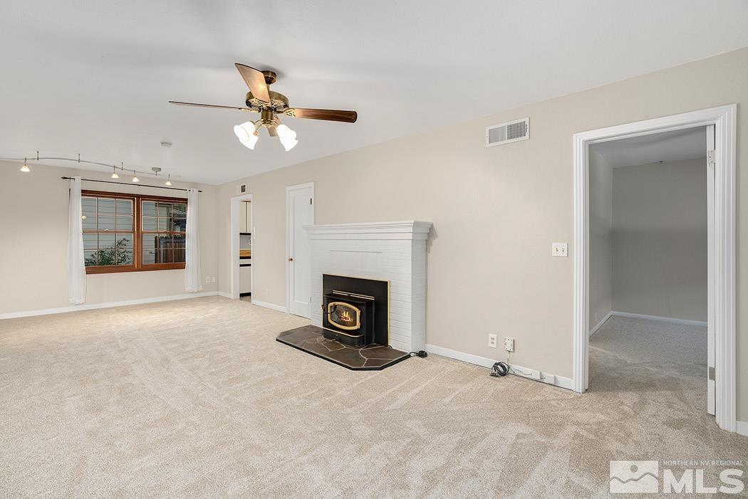 964 Gear Street Reno, NV 89503 - Photo 4 of 21 an empty room with a fireplace and fan