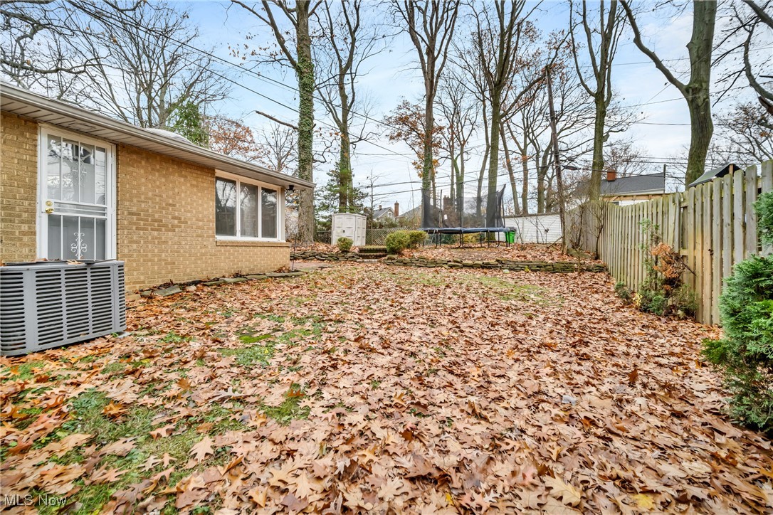 1605 Laclede Road Cleveland, OH 44121 - Photo 24 of 40 View of yard with a fenced backyard, cooling unit, and a trampoline