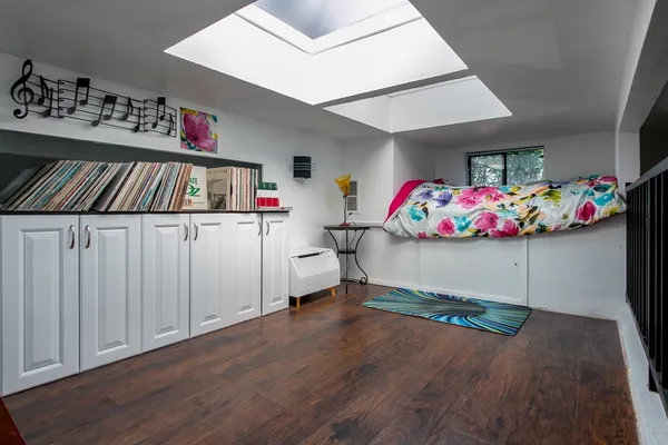 a bedroom with a bed and a chandelier