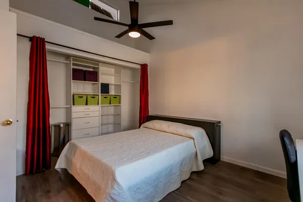 a bedroom with a bed and a window