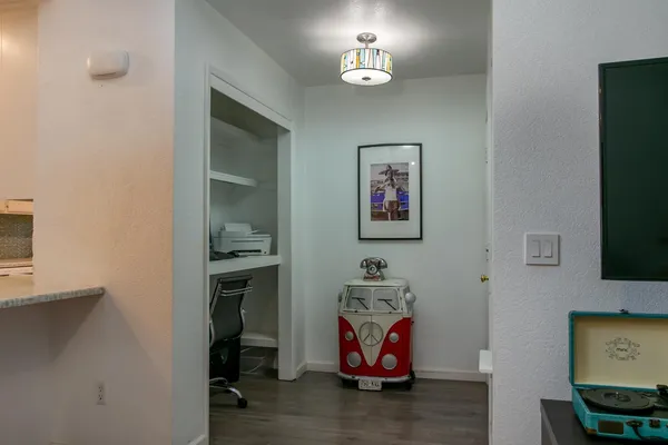 a view of dining room with wooden floor and chandelier