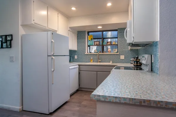 a kitchen with a refrigerator and a sink