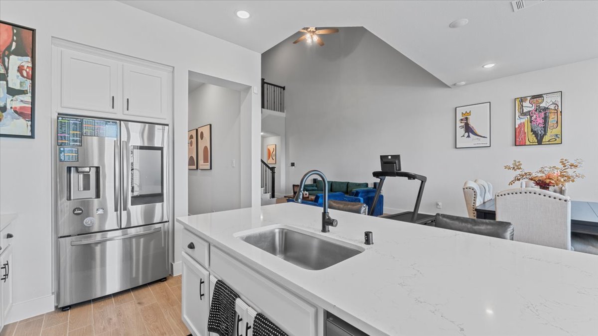 16627 Lake Austin Street Cypress, TX 77433 - Photo 17 of 32 a kitchen with a refrigerator sink and white cabinets