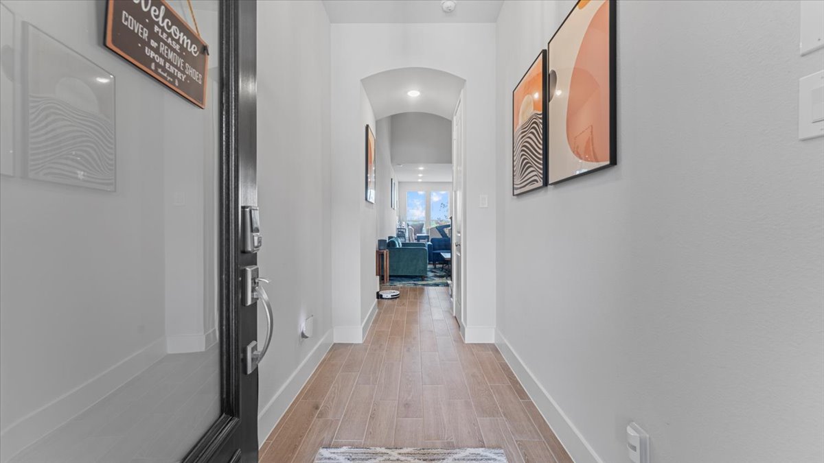 16627 Lake Austin Street Cypress, TX 77433 - Photo 18 of 32 a view of a hallway with wooden floor and staircase