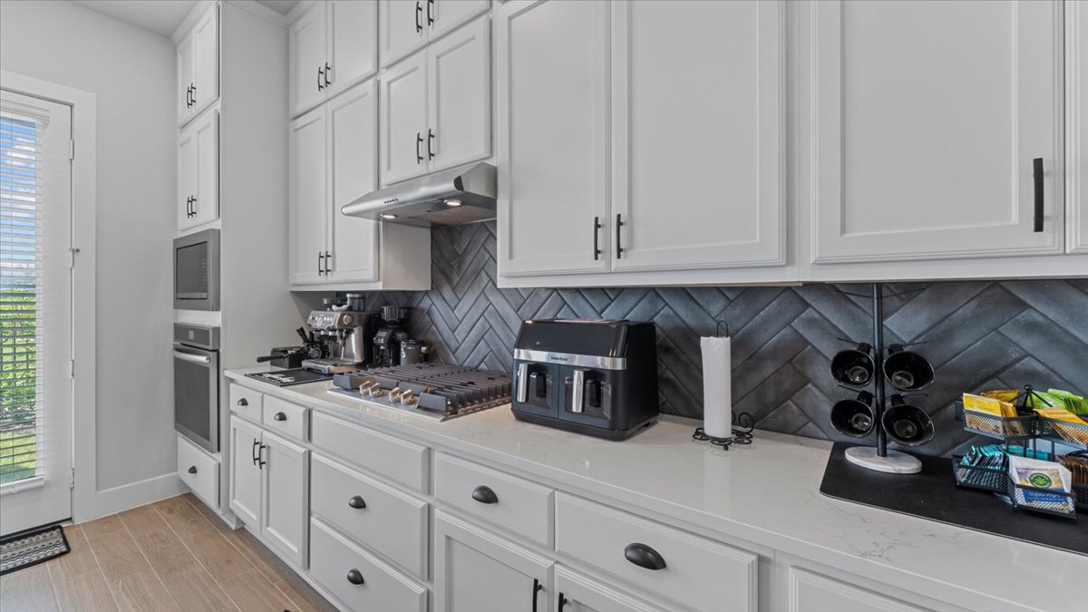 16627 Lake Austin Street Cypress, TX 77433 - Photo 20 of 32 a kitchen with stainless steel appliances granite countertop a sink a stove and a white cabinets