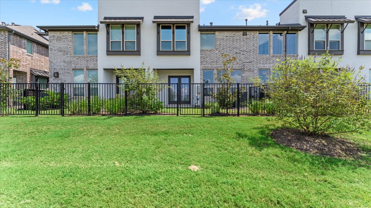 16627 Lake Austin Street Cypress, TX 77433 - Photo 23 of 32 a view of a brick building next to a yard