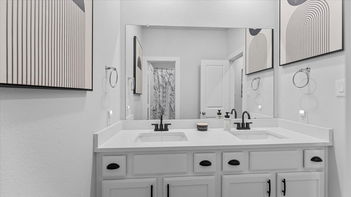 16627 Lake Austin Street Cypress, TX 77433 - Photo 27 of 32 a bathroom with a sink and a mirror