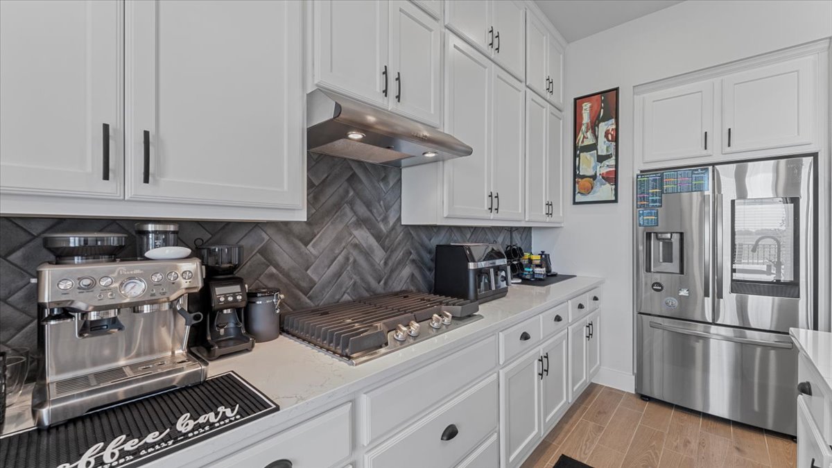 16627 Lake Austin Street Cypress, TX 77433 - Photo 4 of 32 a kitchen with stainless steel appliances a stove and a refrigerator