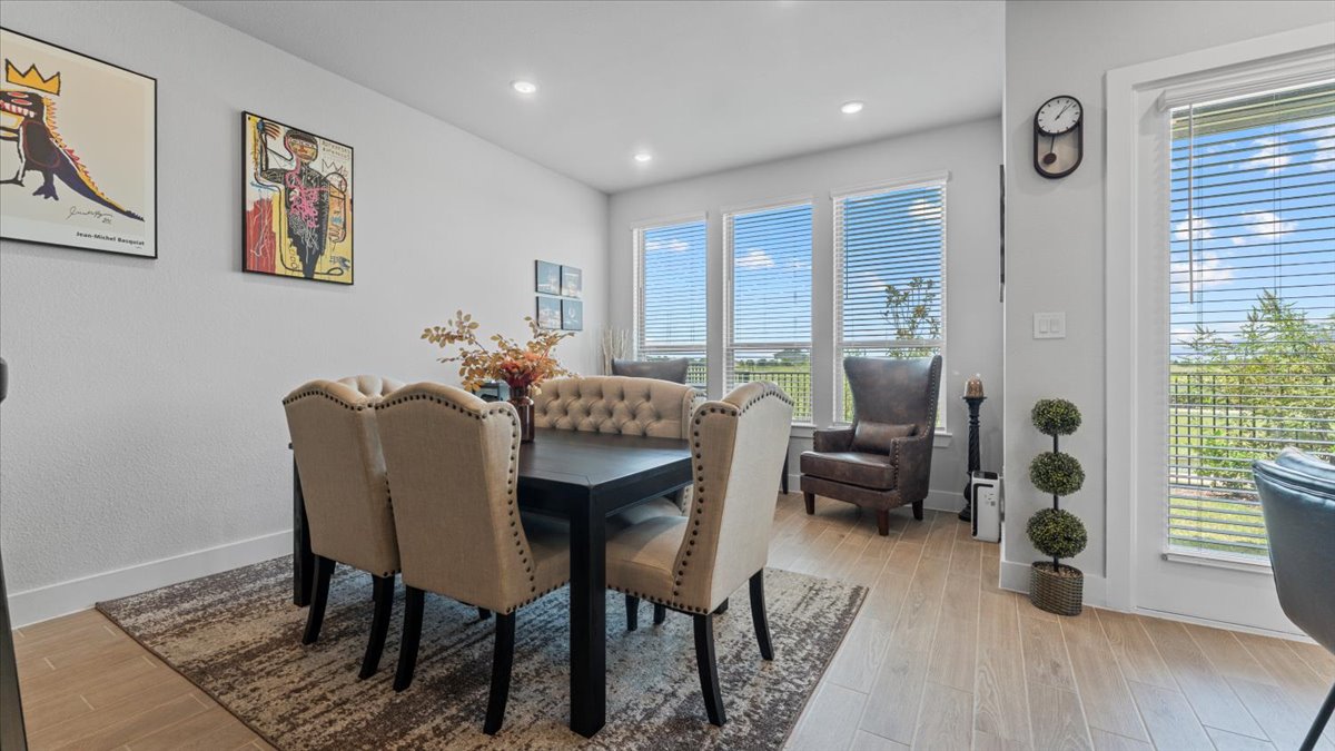16627 Lake Austin Street Cypress, TX 77433 - Photo 7 of 32 a view of a dining room with furniture window and wooden floor